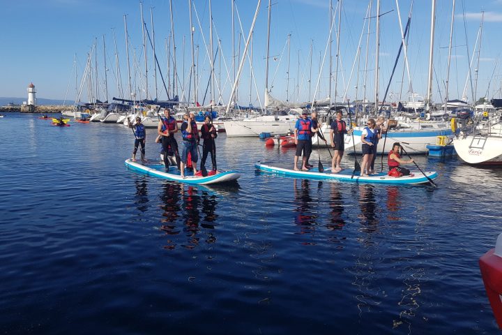 a group of people in a boat on a body of water