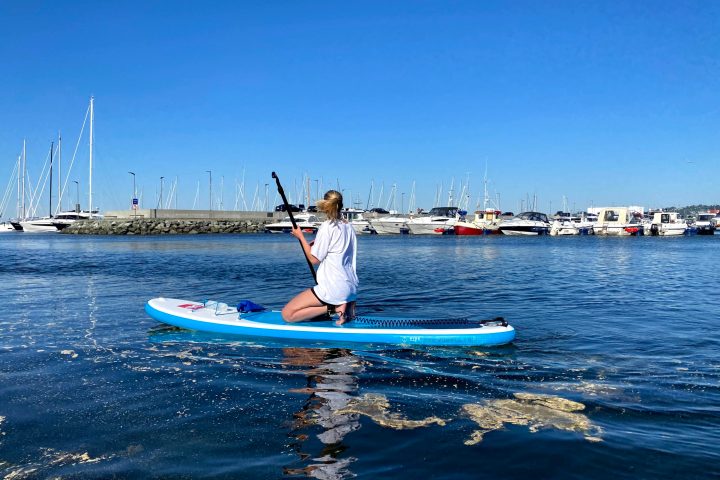 a person riding a surf board on a body of water