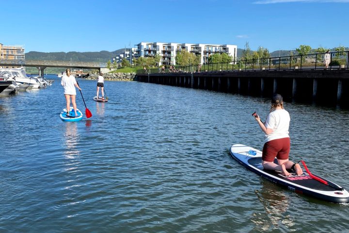 a group of people rowing a boat in a body of water