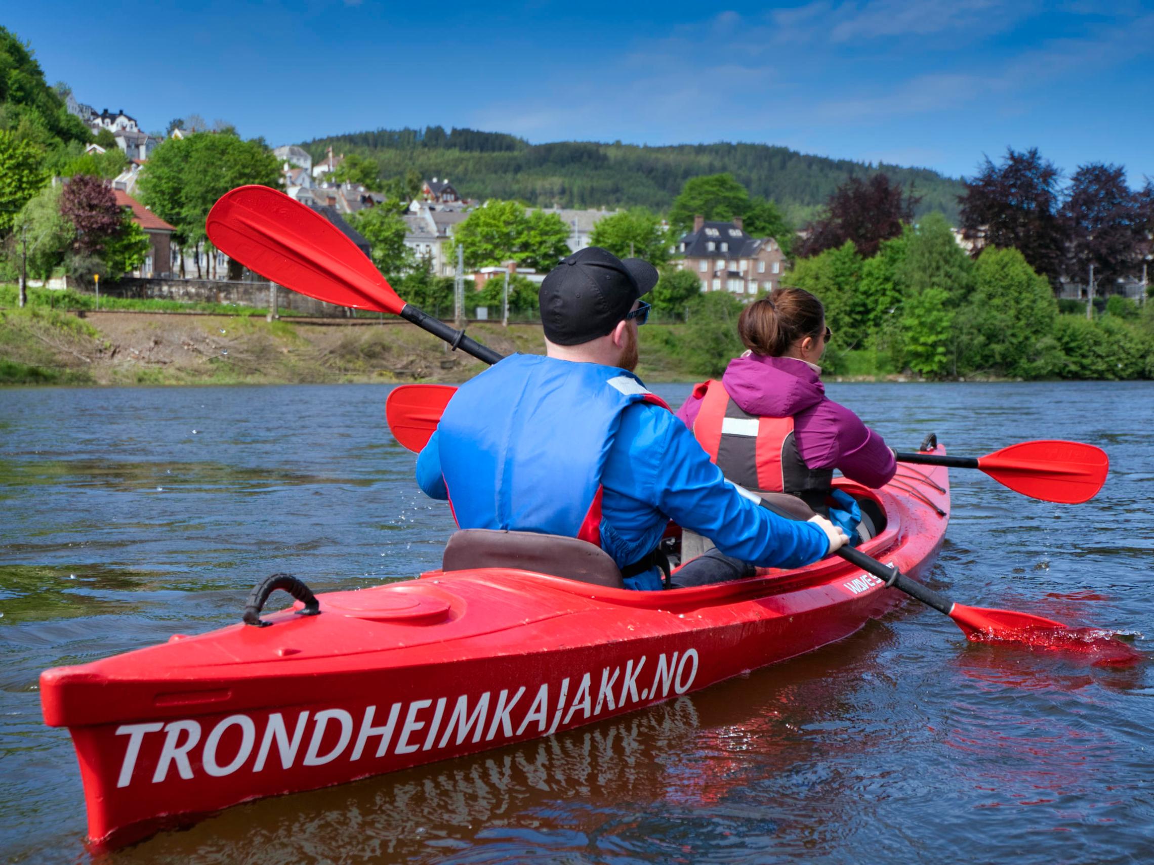 a group of people in a small boat in a body of water