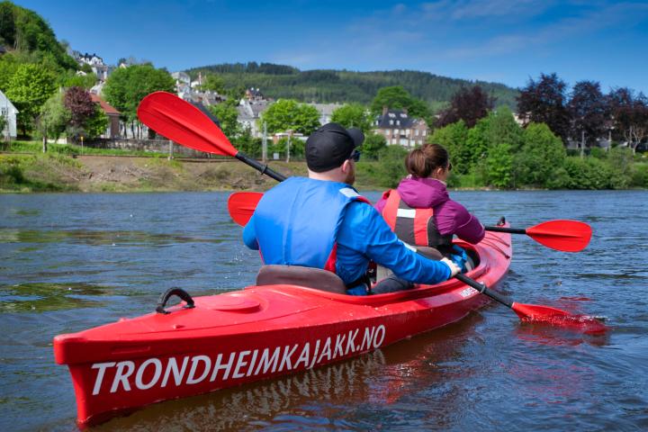 a group of people in a small boat in a body of water