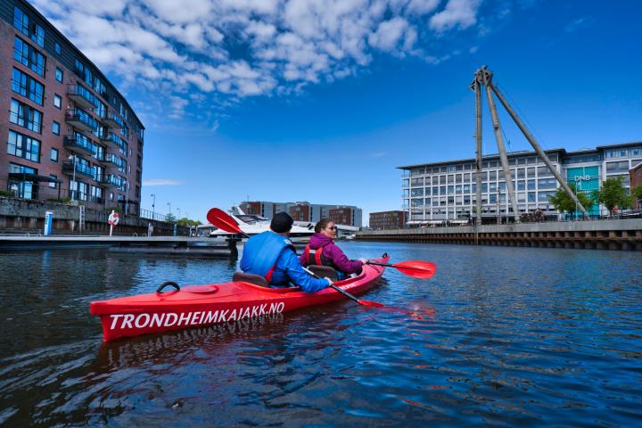 a group of people in a small boat in a body of water