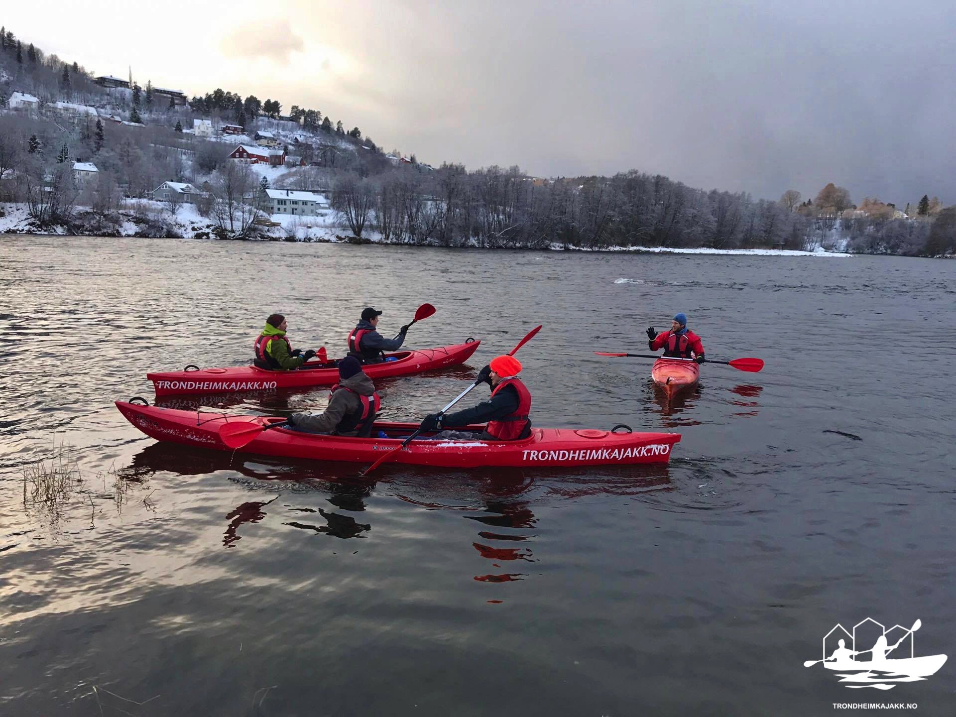 a group of people in a small boat in a body of water