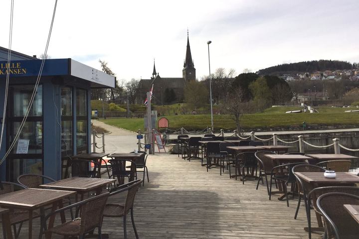 a group of people sitting at a dock