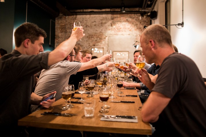 a group of people around a table with wine glasses