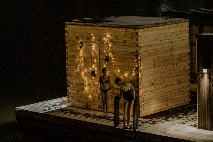 a person standing in front of a brick building