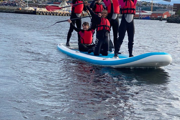 a man standing next to a body of water