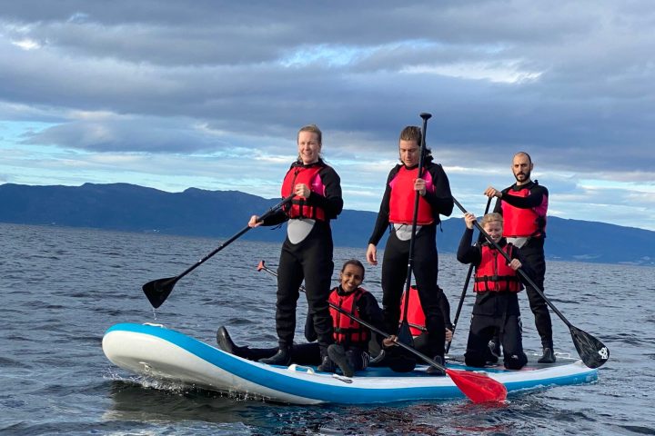 a group of people riding skis on a body of water