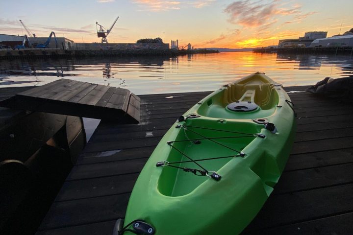 a green boat on a body of water