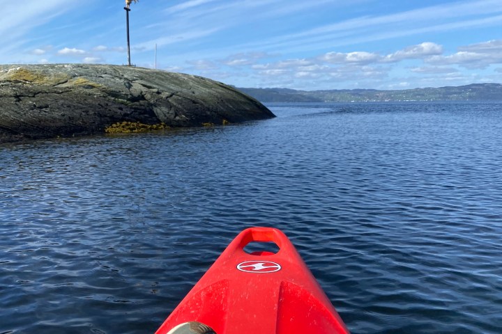 a person sitting in a boat on a body of water