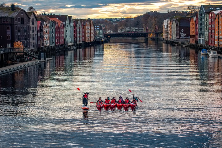 a group of people in a harbor next to a body of water
