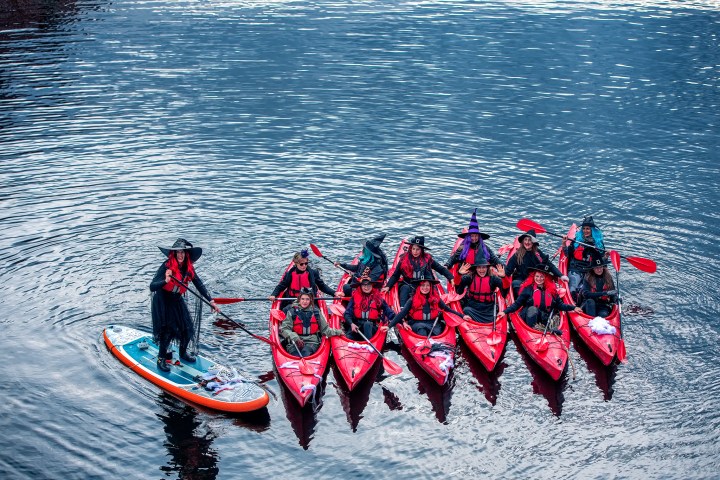 a group of people riding skis on a body of water