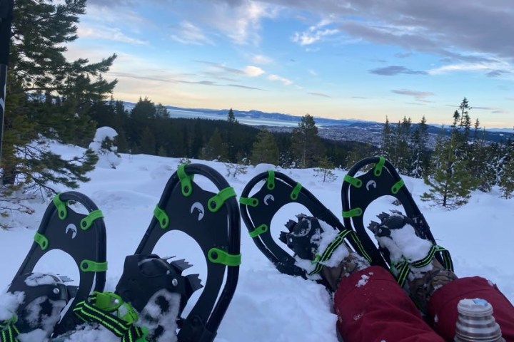 a group of people sitting in the snow