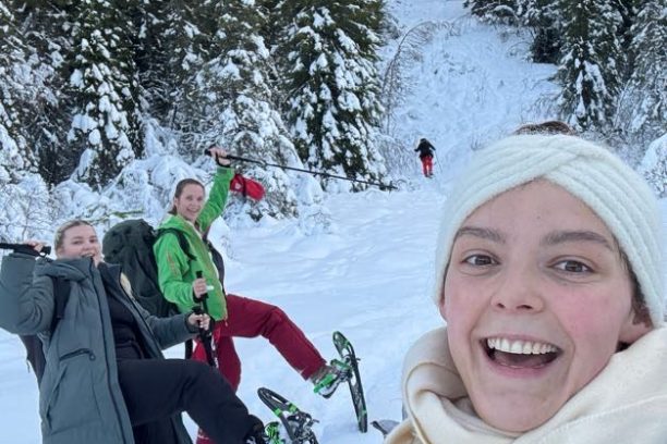 a group of people posing for a picture in the snow
