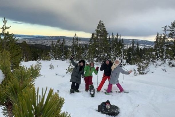 a couple of people that are standing in the snow