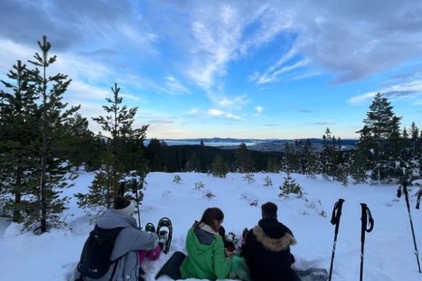 a group of people riding skis on top of a snow covered slope