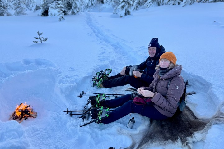a person that is sitting in the snow