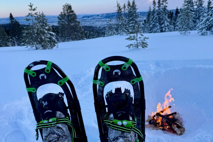 a group of people standing on top of a snow covered slope