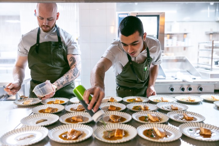 a man sitting at a table with a plate of food