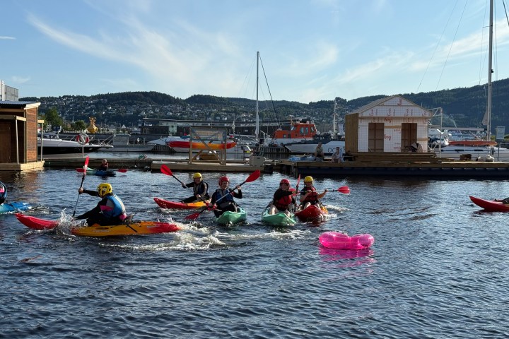 a group of people in a small boat in a body of water