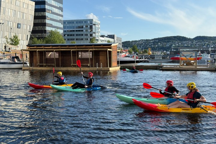 a group of people rowing a boat in the water